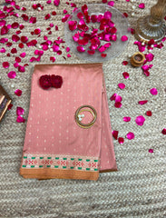 Coaral pastel peach crepe silk saree with minakari work.