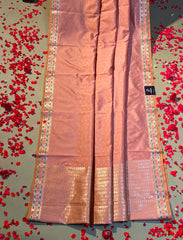 Coaral pastel peach crepe silk saree with minakari work.